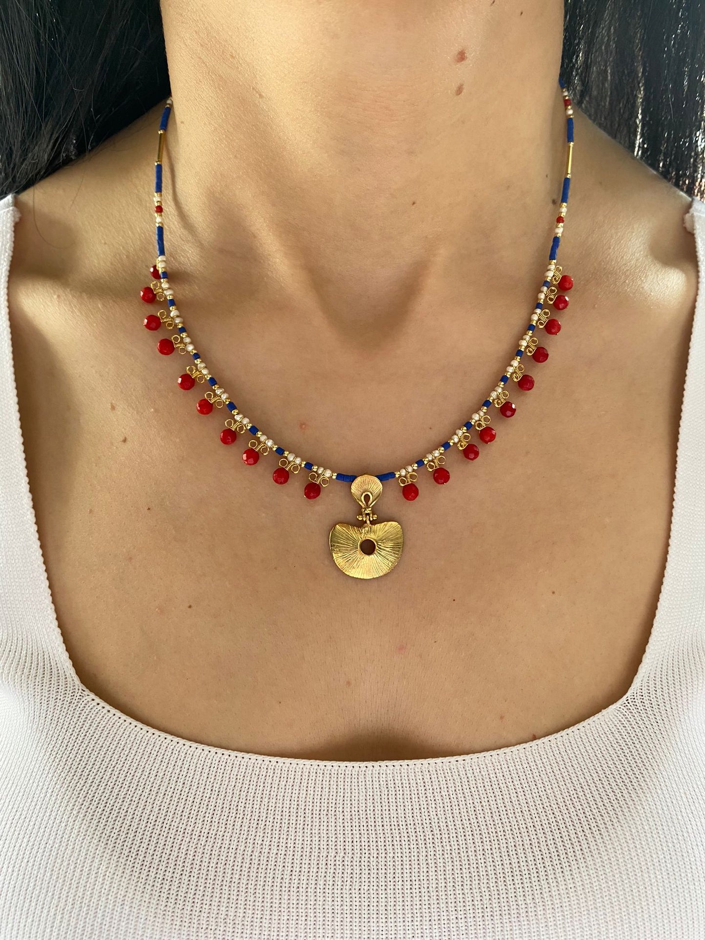 Hera necklace with coral and lapis lazuli gemstones, 925 silver adorned with gold plating, displayed elegantly on a model.