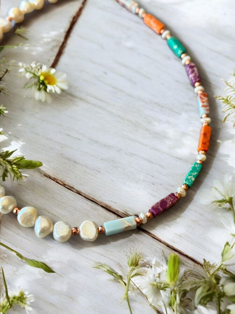 Liza Necklace with Variscite, Hematite, and Pearl - Rose Gold Plated Silver featuring vibrant gemstone beads arranged alongside delicate white flowers.