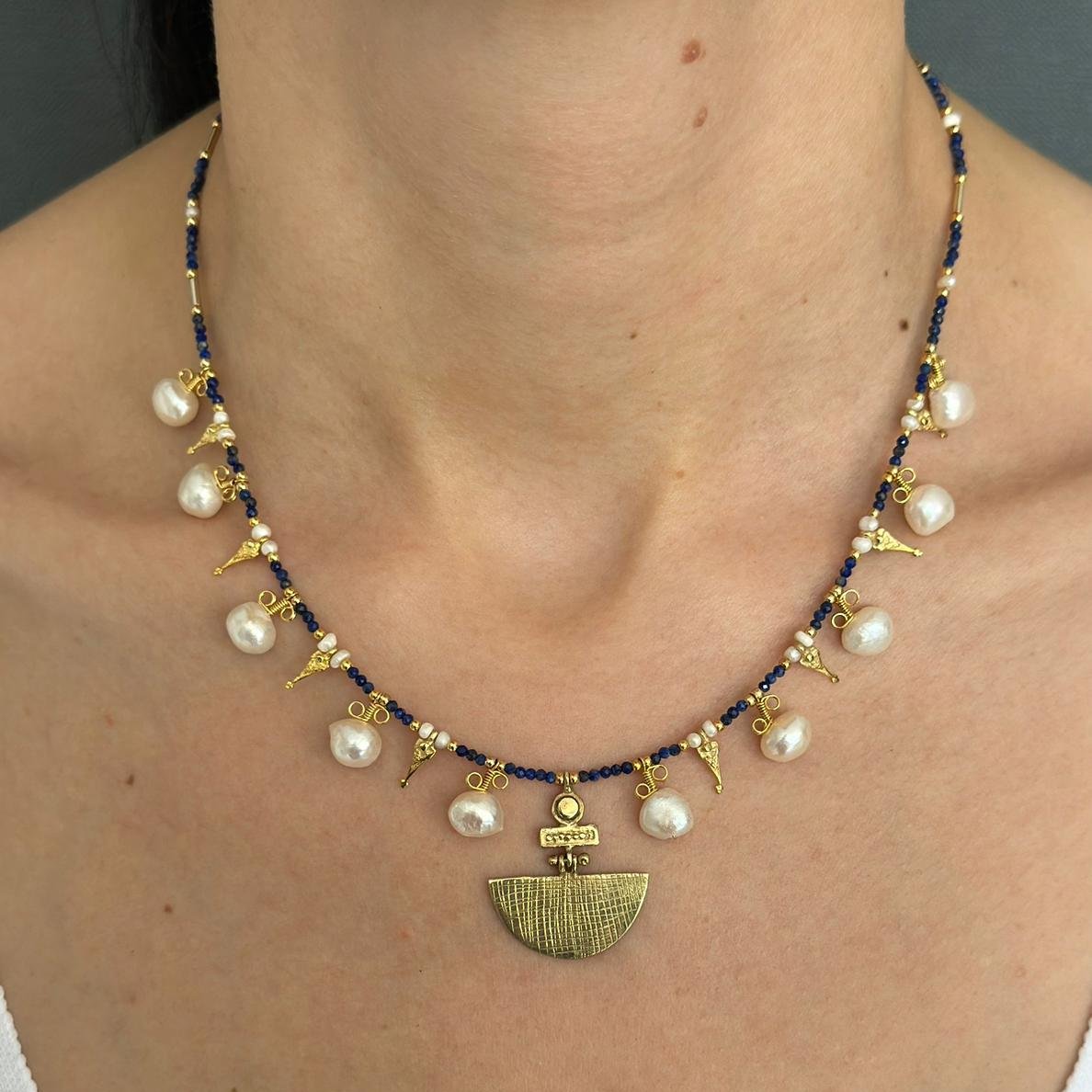 Selena Lapis Lazuli Necklace and Earrings Set - 14K Gold Plated, adorned with pearls and intricate gold pendants, worn by a model.