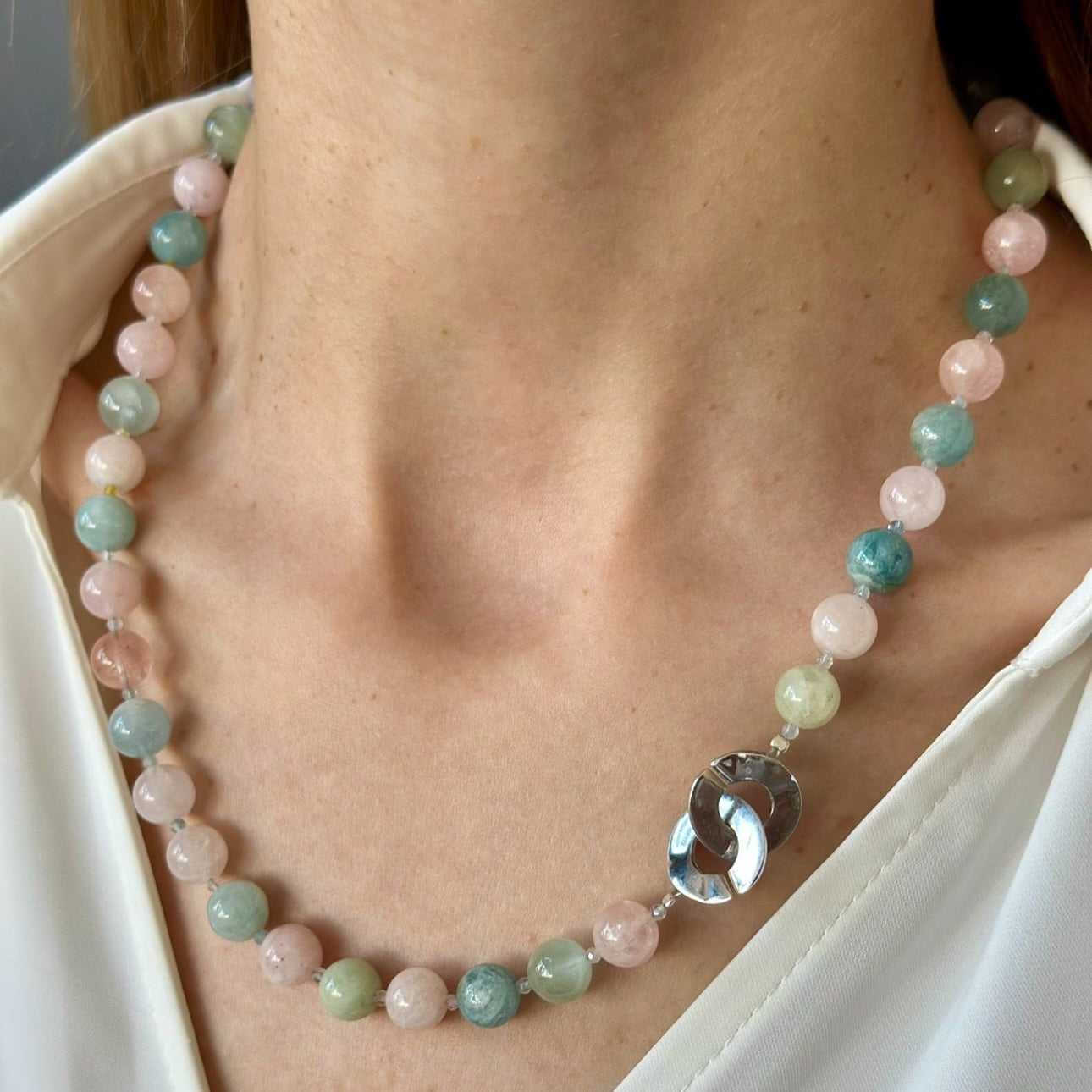 Necklace with multicolored beads and a large silver pendant 