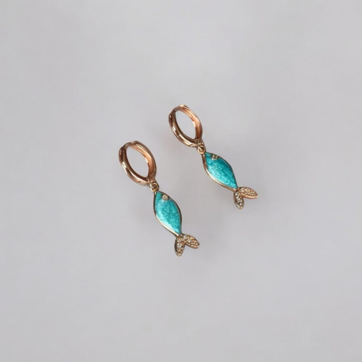 Azure Fish Earrings in handcrafted 925 silver with rose gold plating, showcasing blue enamel and fine detailing.