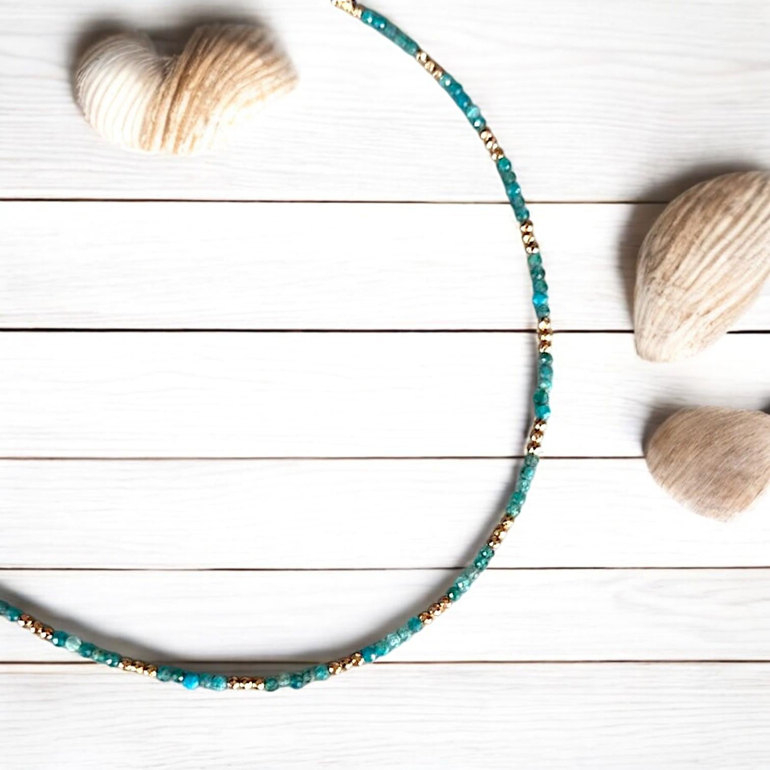 Azure Silver Fish and Apatite gemstone jewellery set featuring necklaces and earrings displayed in an elegant flat-lay.