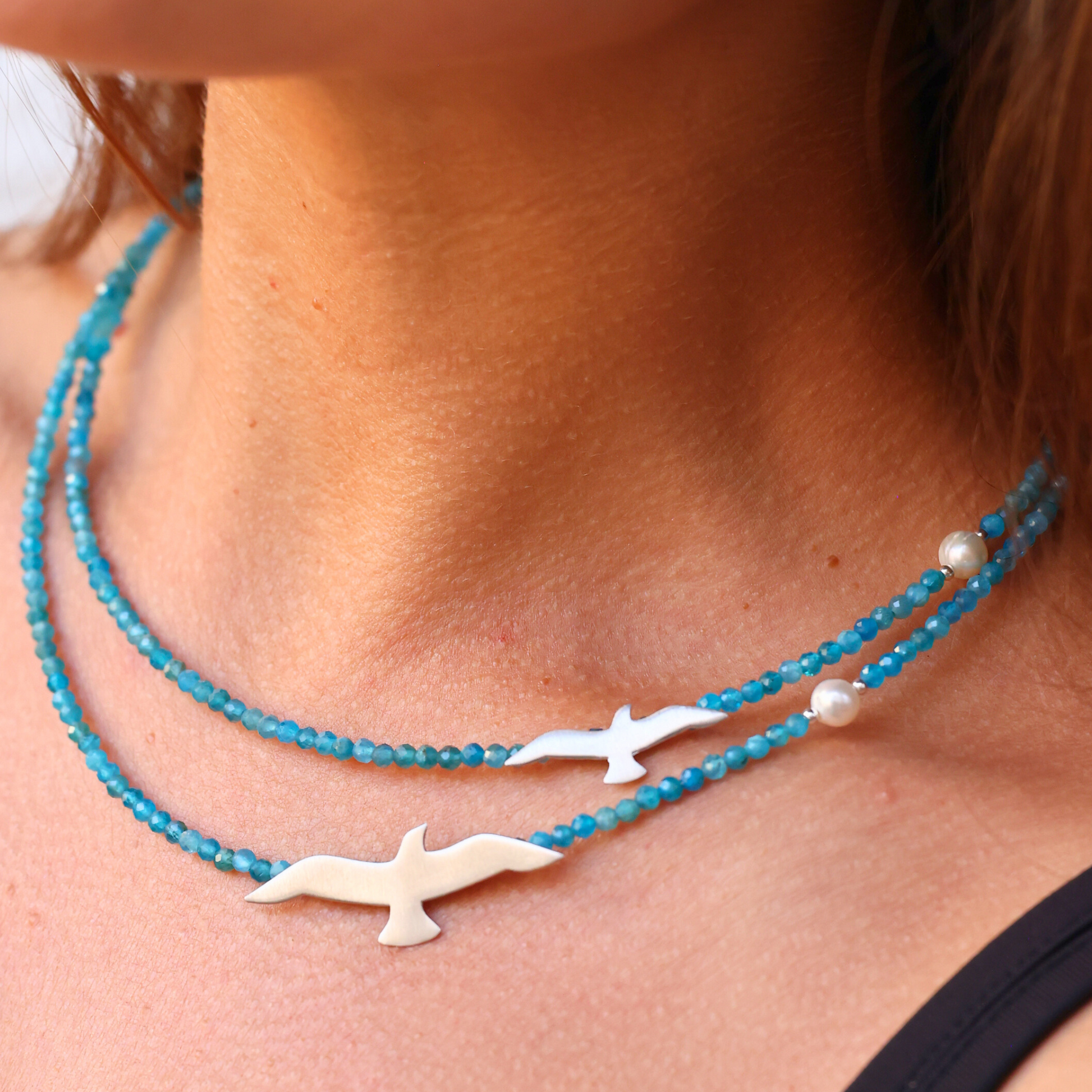 Elegant Big and Small Seagull Apatite Silver Necklace on a model's neck, showcasing its stunning design and craftsmanship.