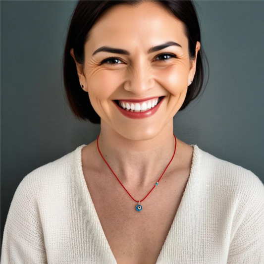 Woman wearing a stylish Evil Eye red cord necklace, featuring a protective eye charm. Perfect fashion accessory.