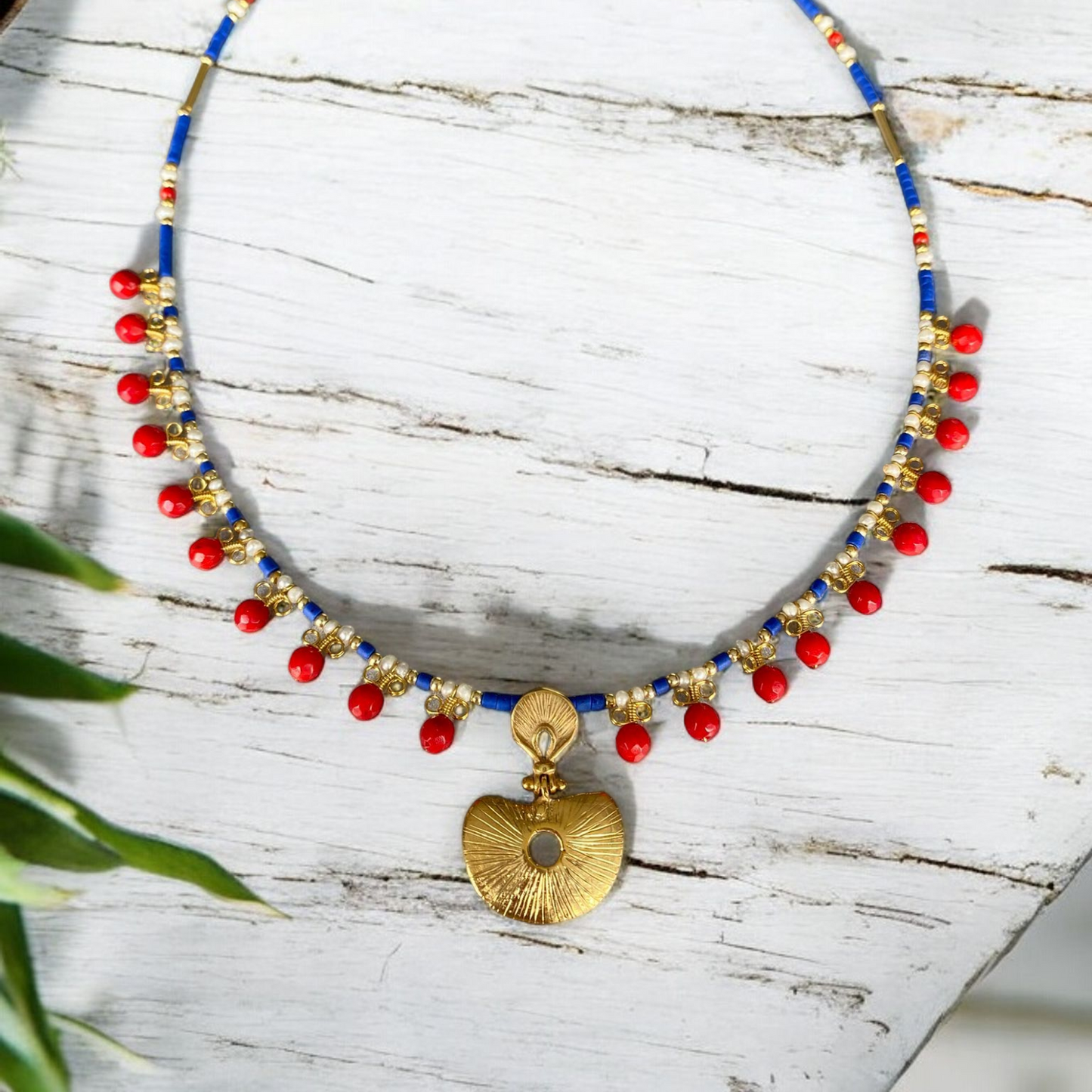 Hera Coral and Lapis Lazuli Gemstone Necklace in 925 Silver with Gold Plating featuring vibrant red coral beads and a gold pendant on a blue gemstone chain