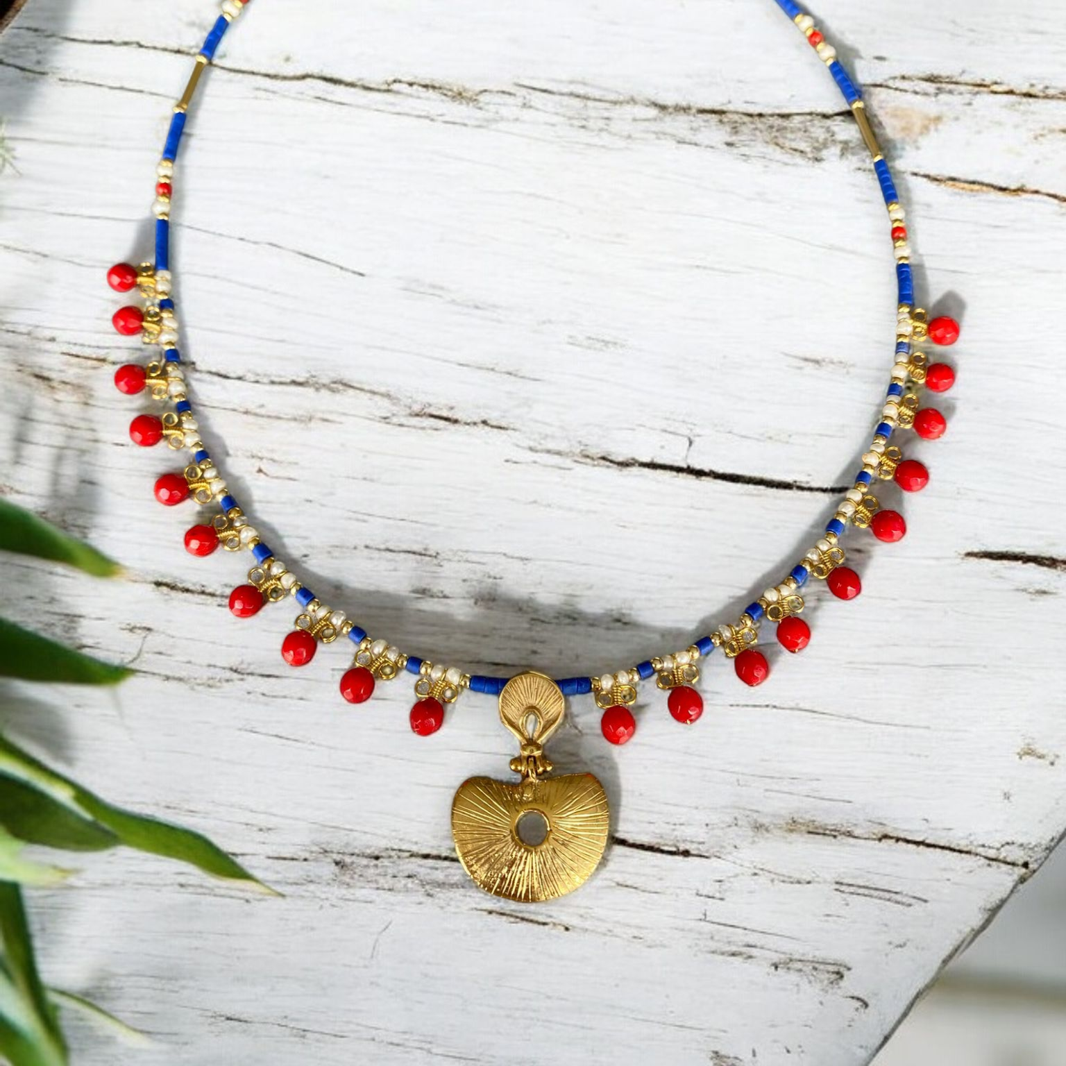 Hera Coral and Lapis Lazuli Gemstone Necklace in 925 Silver with Gold Plating featuring vibrant red coral beads and a gold pendant on a blue gemstone chain