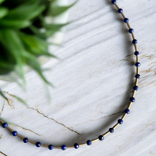 Melia Lapis Lazuli Gemstone and Silver Necklace with blue beads and silver spacers on a marble background