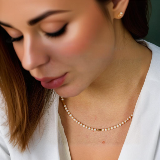 Elegant freshwater pearls and gold plated silver necklace showcased on a model. Minimalist jewellery design.