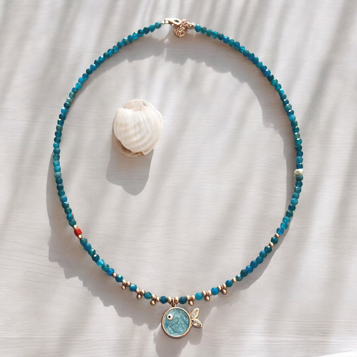 Phuket Apatite Fish Pendant Necklace - Rose Gold Plated 925 Silver, showcasing a delicate rose gold fish charm on a vibrant blue apatite bead chain.