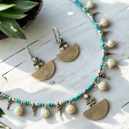 Selena Turquoise Necklace and Earrings Set featuring intricate turquoise beads, delicate pearls, and brass half-moon pendants.